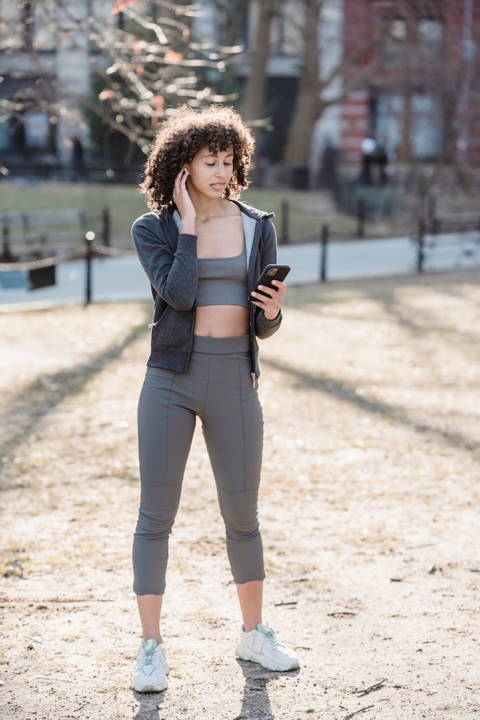 A woman checking her training routine on her phone.